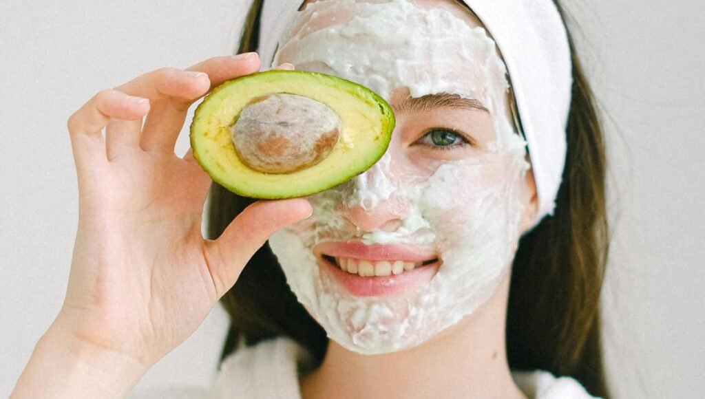 Woman applying Avocado and Yogurt Nourishing Mask, a Homemade Face Mask for Glowing Skin and natural skincare routine.